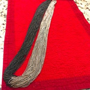 Stunning long black and silver toned necklace.